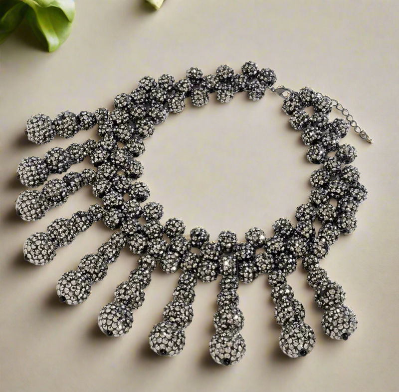 Bold gunmetal rhinestone bib necklace with clustered ball-shaped drop accents