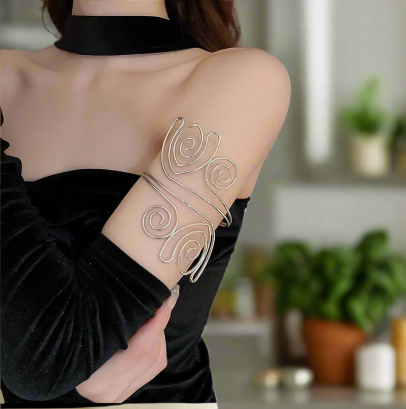 Silver-tone spiral swirl arm cuff for women, adjustable open bangle for upper arm, modern boho chic statement jewelry.