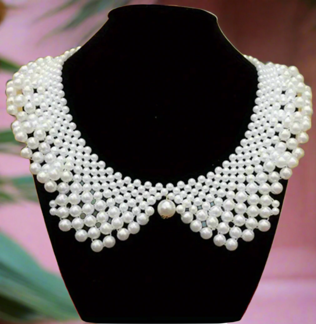 White faux pearl Peter Pan collar bib necklace, vintage-inspired statement jewelry on black bust display
