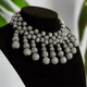 Bold gunmetal rhinestone bib necklace with clustered ball-shaped drop accents