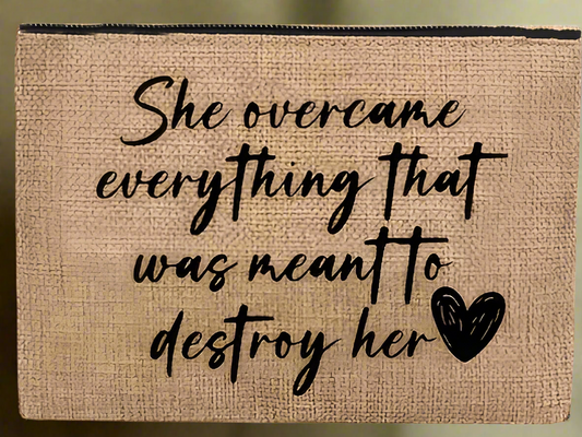 A chic jute tote with a bold Black woman illustration labeled “QUEEN,” paired with a natural burlap pouch featuring the quote “She overcame everything that was meant to destroy her,” held in elegant hands.