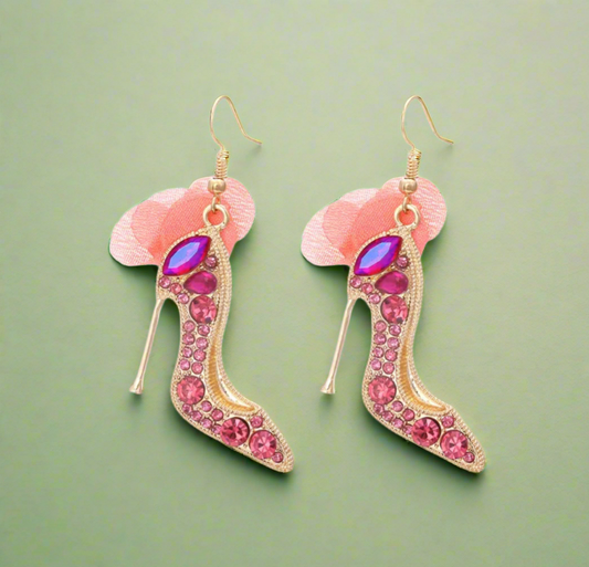 High heel-shaped pink rhinestone earrings with soft blush tulle detail and gold hooks.
