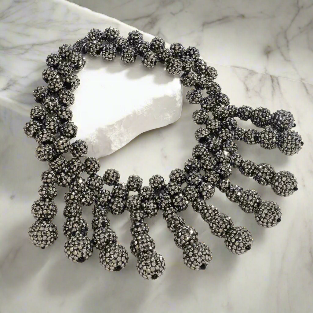 Bold gunmetal rhinestone bib necklace with clustered ball-shaped drop accents