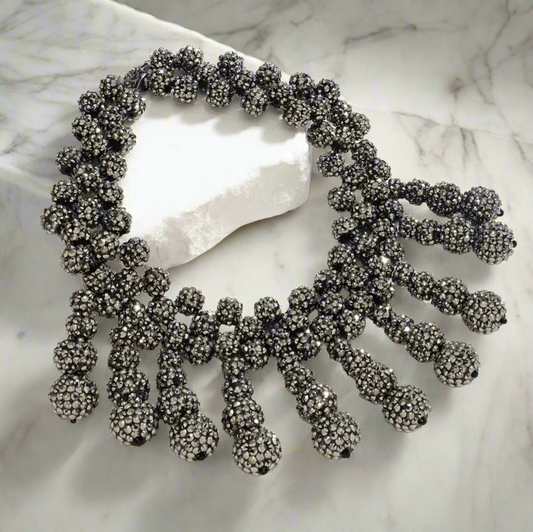 Bold gunmetal rhinestone bib necklace with clustered ball-shaped drop accents